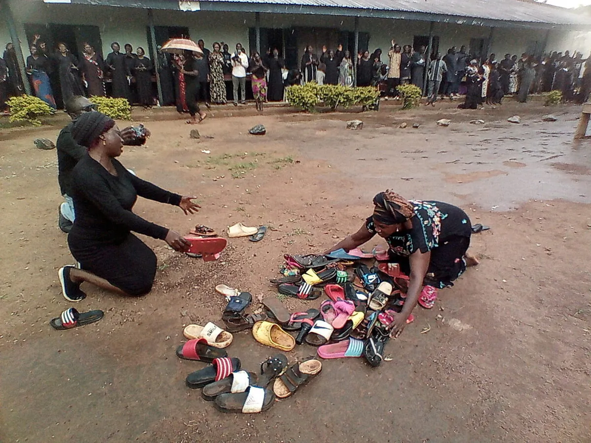 Parents of students abducted at Bethel Baptist High School pray for their safe return around discarded shoes left behind by the children, in Kaduna, Nigeria, on July 9, 2021. (Bosan Yakusak/Reuters)