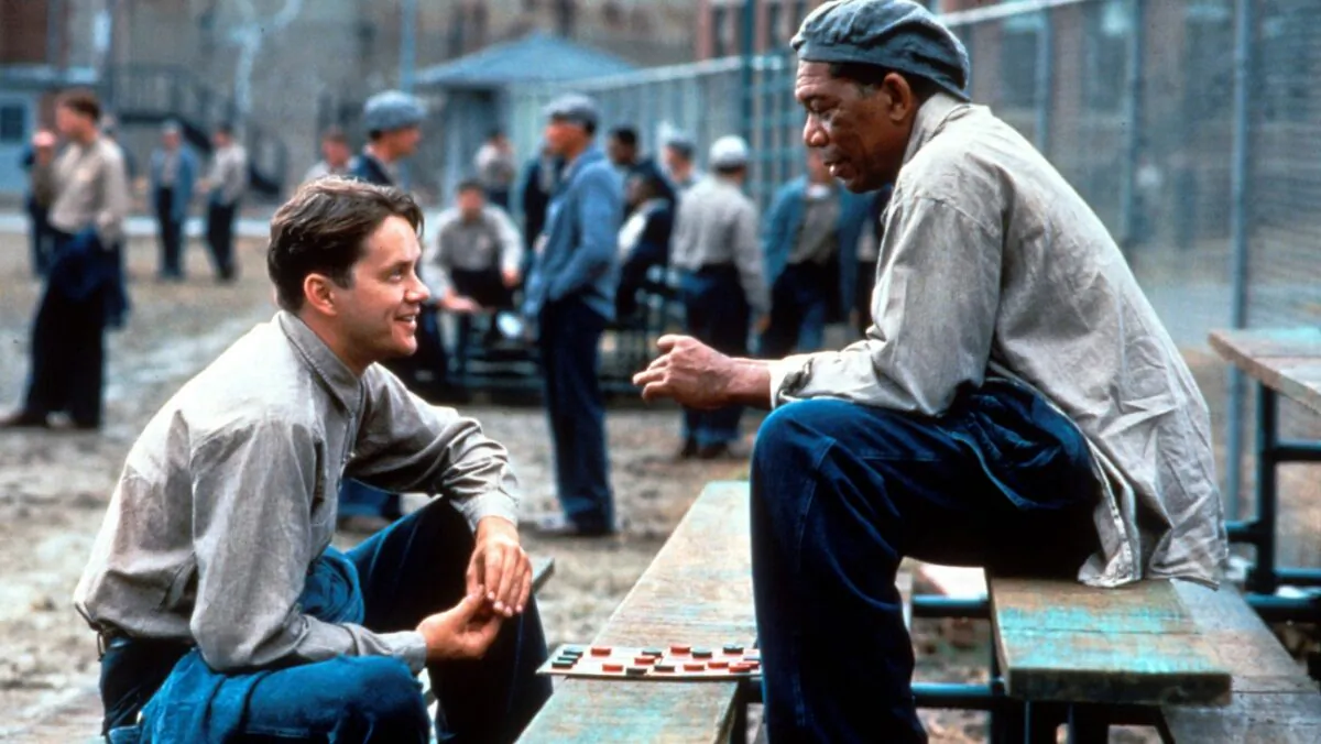 Tim Robbins (L) and Morgan Freeman play characters who find friendship in a dark and hopeless prison. (Columbia Pictures)