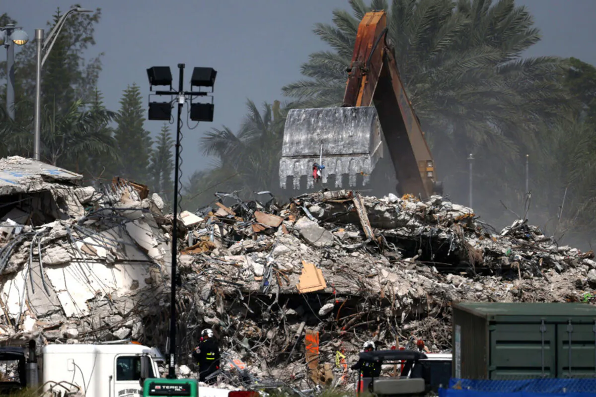 Excavators dig through the remains from the collapsed 12-story Champlain Towers South condo building in Surfside, Fla., on July 9, 2021. (Anna Moneymaker/Getty Images)