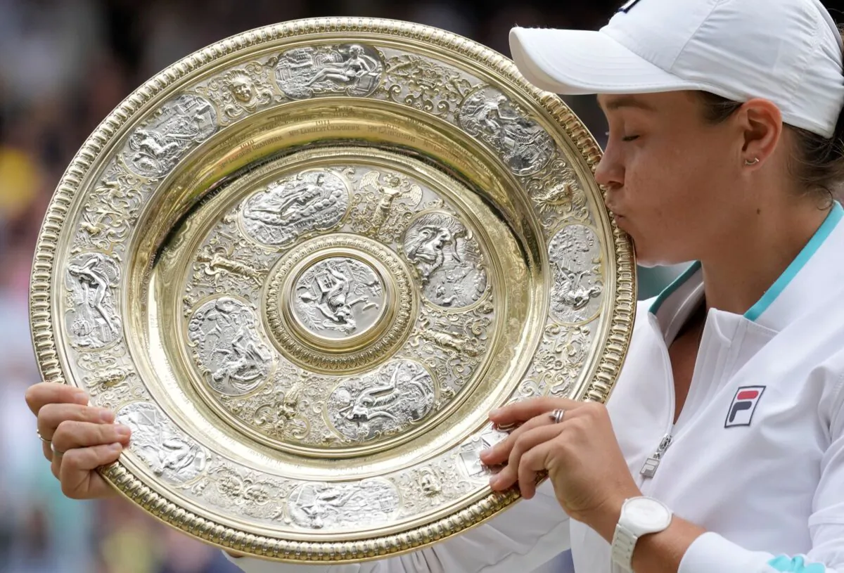 Australia's Ashleigh Barty poses with the trophy for the media after winning the women's singles final after defeating the Czech Republic's Karolina Pliskova on day twelve of the Wimbledon Tennis Championships in London, England, on July 10, 2021. (Kirsty Wigglesworth/AP Photo)