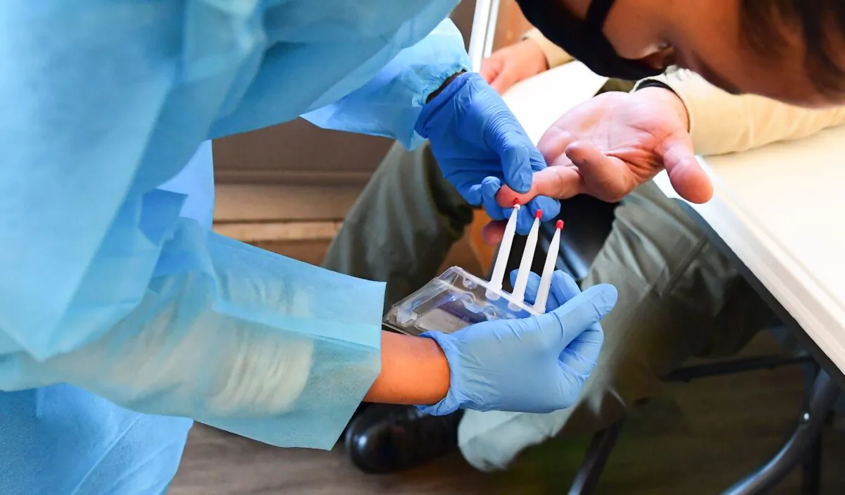 A person is tested for COVID-19 antibodies in Pico Rivera, Calif., on Feb. 17, 2021. (Frederic J. Brown/AFP via Getty Images)