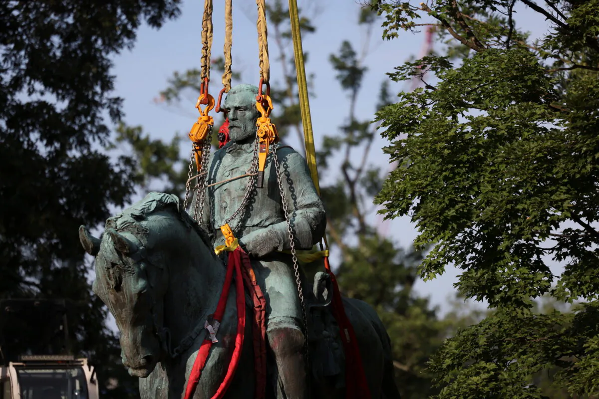 A statue of Confederate Gen. Robert E. Lee is removed after a yearslong legal battle over the contentious monument in Charlottesville, Va., on July 10, 2021. (Evelyn Hockstein/Reuters)