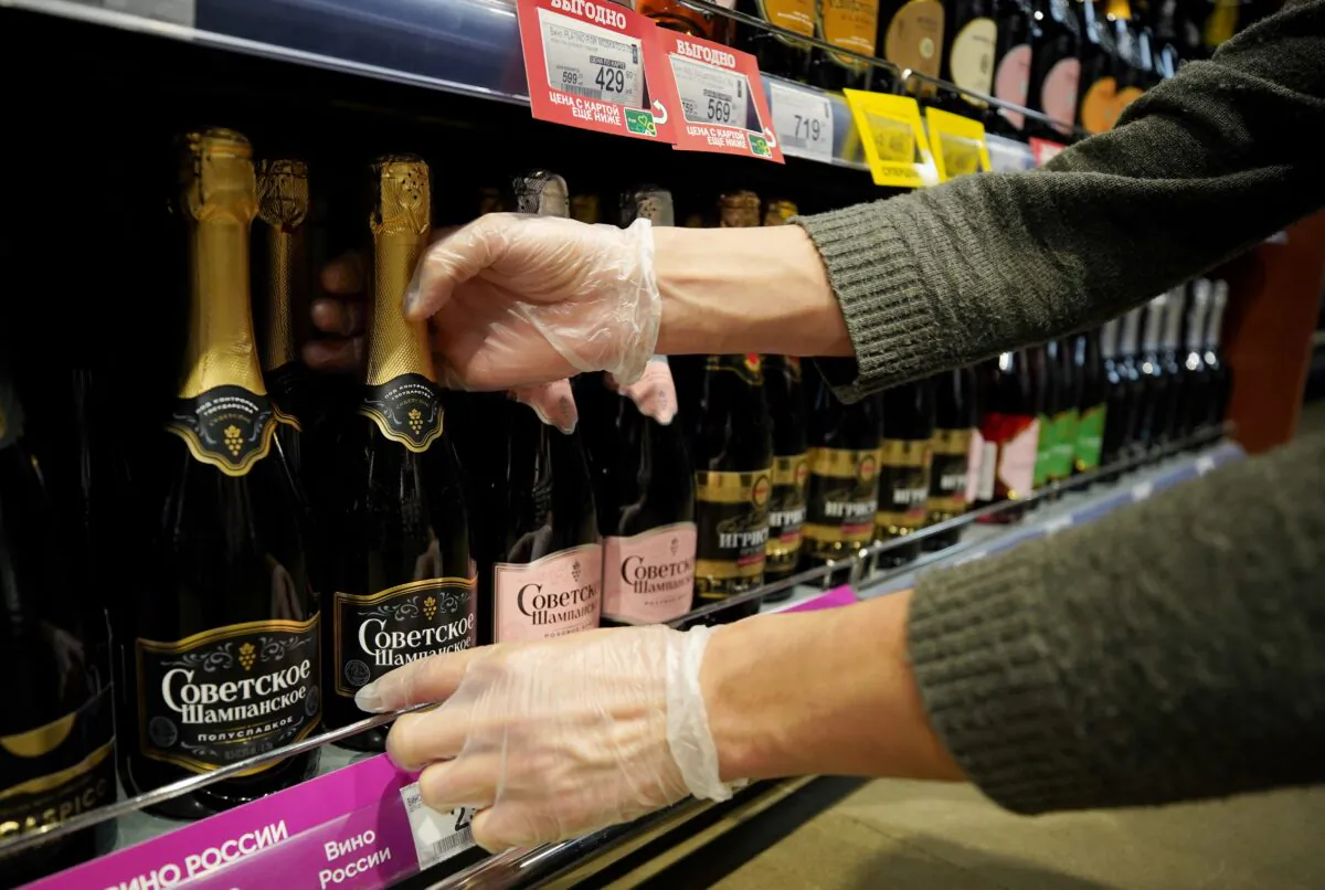 An employee arranges bottles of Russian sparkling wine at a supermarket in Moscow on July 5, 2021. (Tatyana Makeyeva/Reuters)
