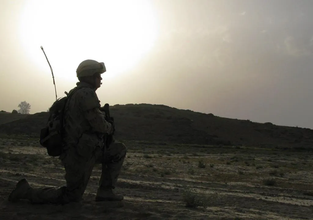 A Canadian soldier keeps a close watch as one of his men investigates a suspicious device near a road between two of Canada’s bases in southern Afghanistan on June 2, 2009. (The Canadian Press/Colin Perkel)