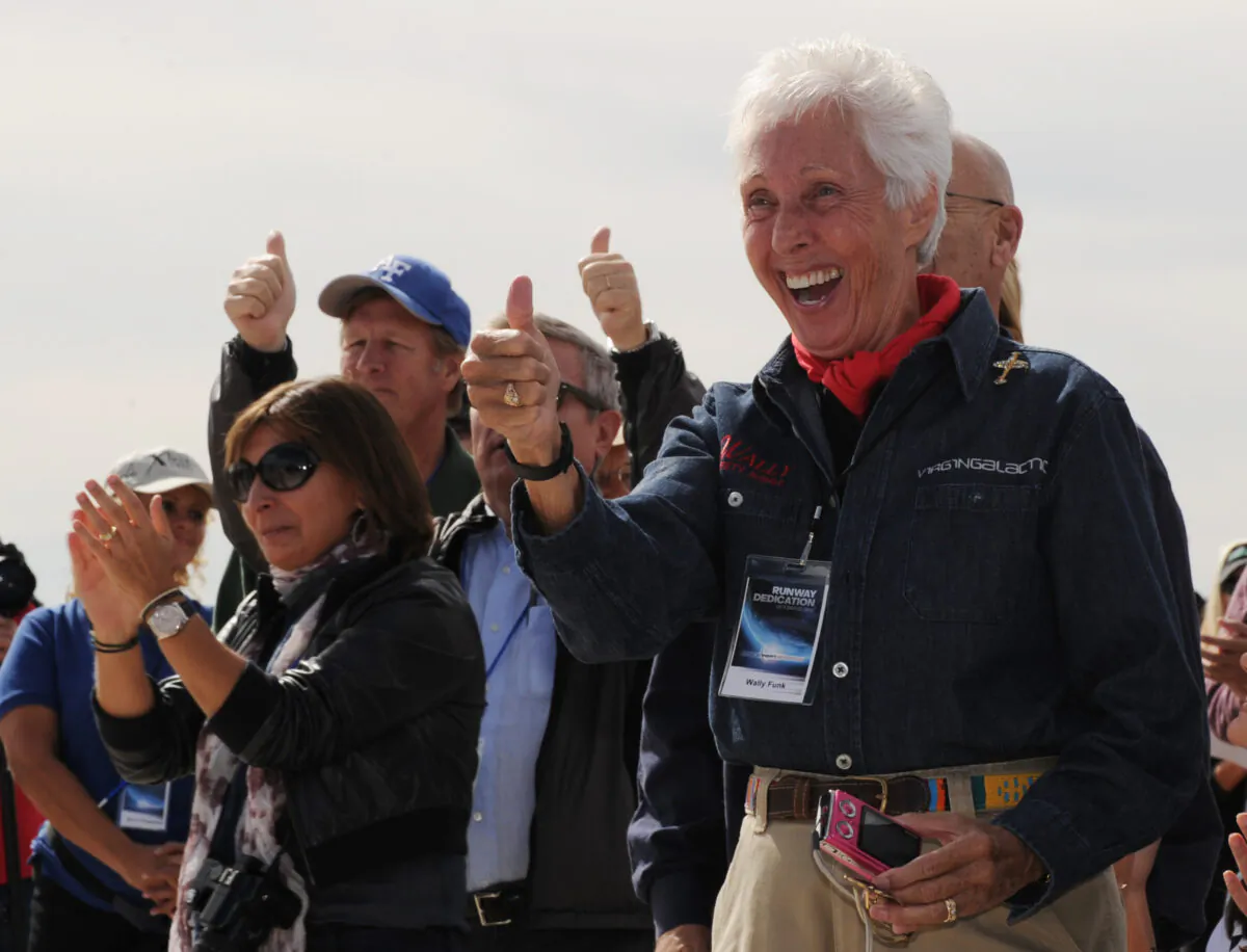 Wally Funk (R) celebrates before the Virgin Galactic VSS Enterprise spacecraft makes it's first public landing during the Spaceport America runway dedication ceremony near Las Cruces, N.M., on Oct. 22, 2010. (Mark Ralston/AFP via Getty Images)