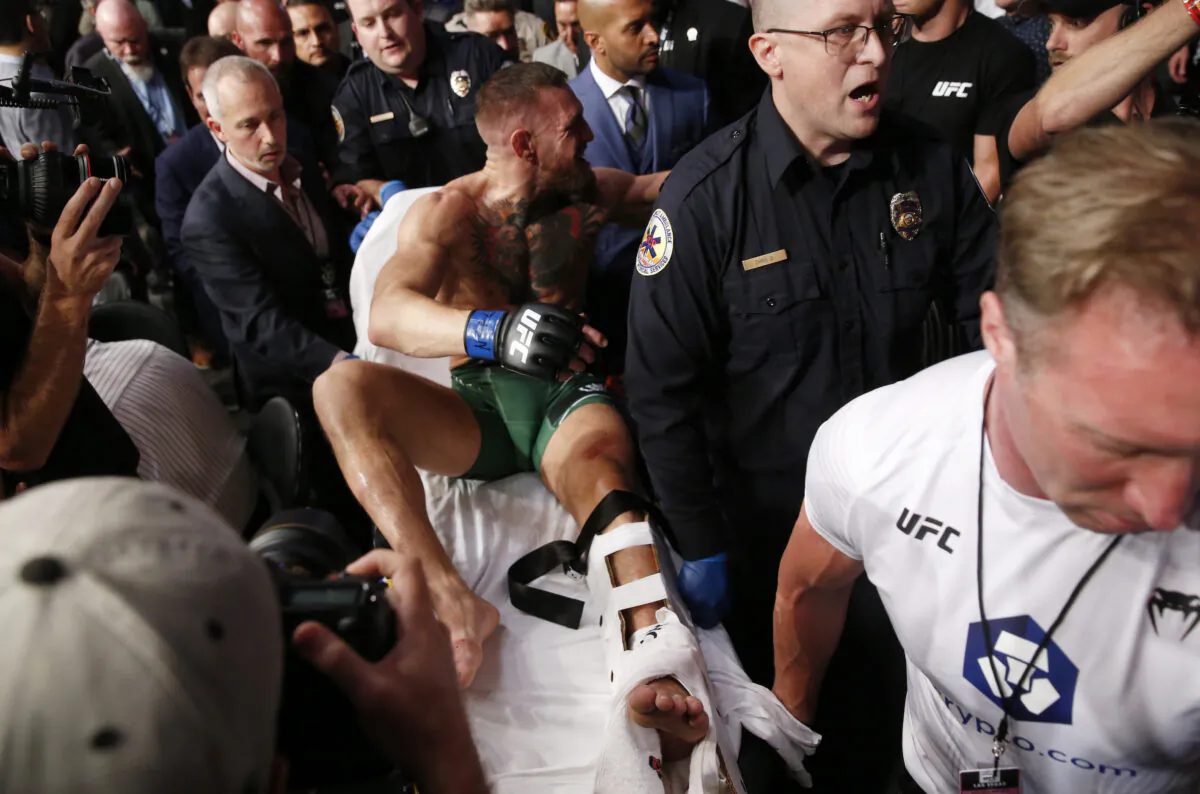 Conor McGregor is stretchered from the octagon after snapping his ankle in a fight with Dustin Poirier during UFC264 at T-Mobile Arena, Las Vegas, on July 10, 2021. (Steve Marcus/Reuters)