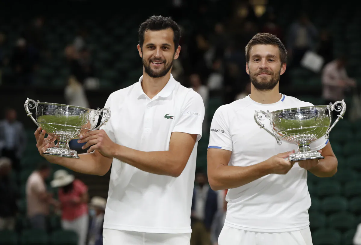 Croatia's Mate Pavic and Nikola Mektic celebrate with the trophies after winning the men's doubles final against Spain's Marcel Granollers and Argentina's Horacio at The Wimbledon Tennis Championships in London, UK, on July 10, 2021. (Paul Childs/Reuters)