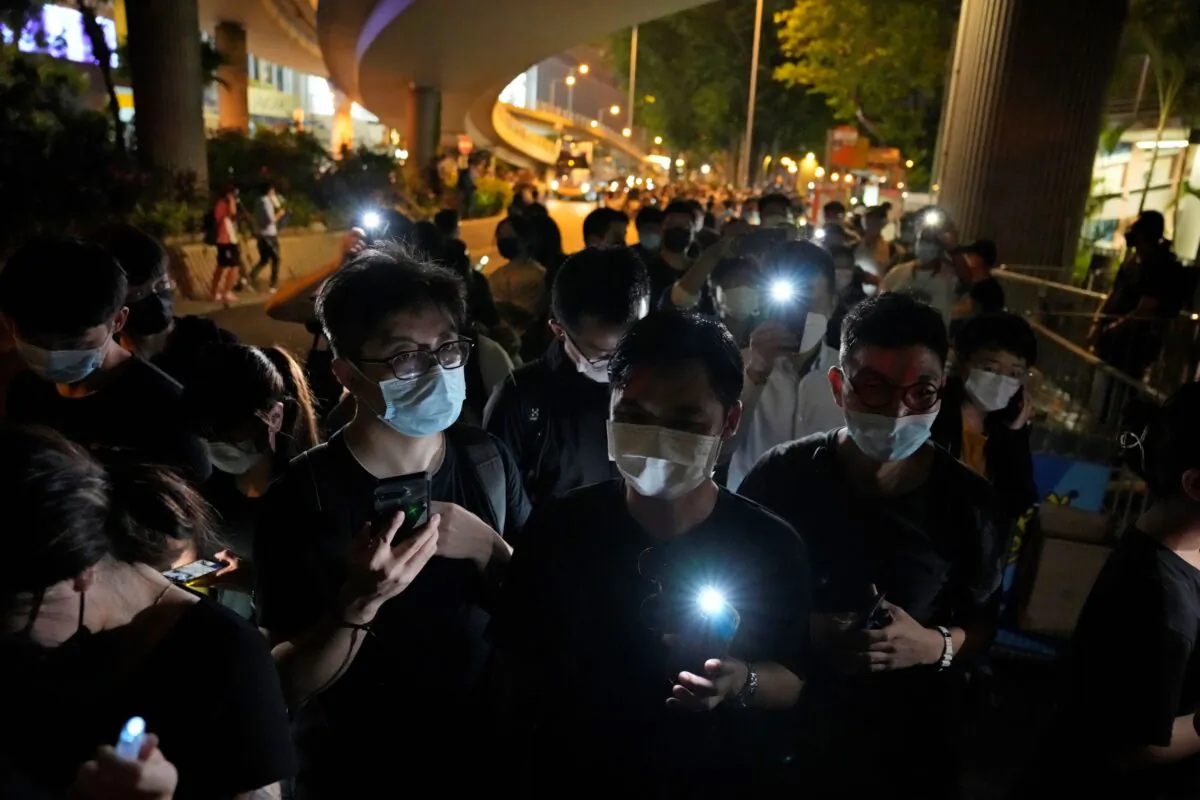 People hold LED candles to mark the anniversary of the military crackdown on a pro-democracy student movement in Beijing, outside Victoria Park in Hong Kong, on June 4, 2021. (Kin Cheung/File/AP Photo)