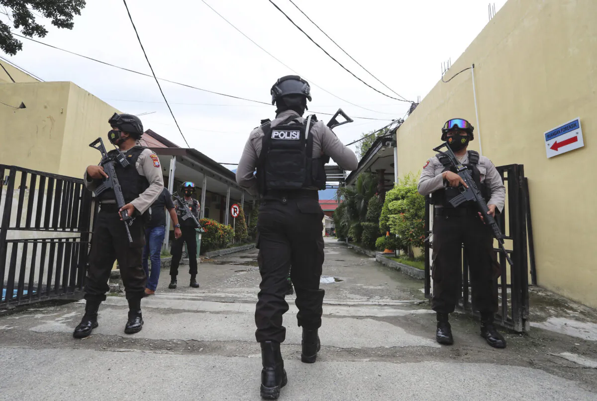 Police officers stand guard at a local police hospital where the bodies of militants killed during a raid were taken to, in Palu, Central Sulawesi, Indonesia, on July 11, 2021. (Josua Marunduh/AP Photo)