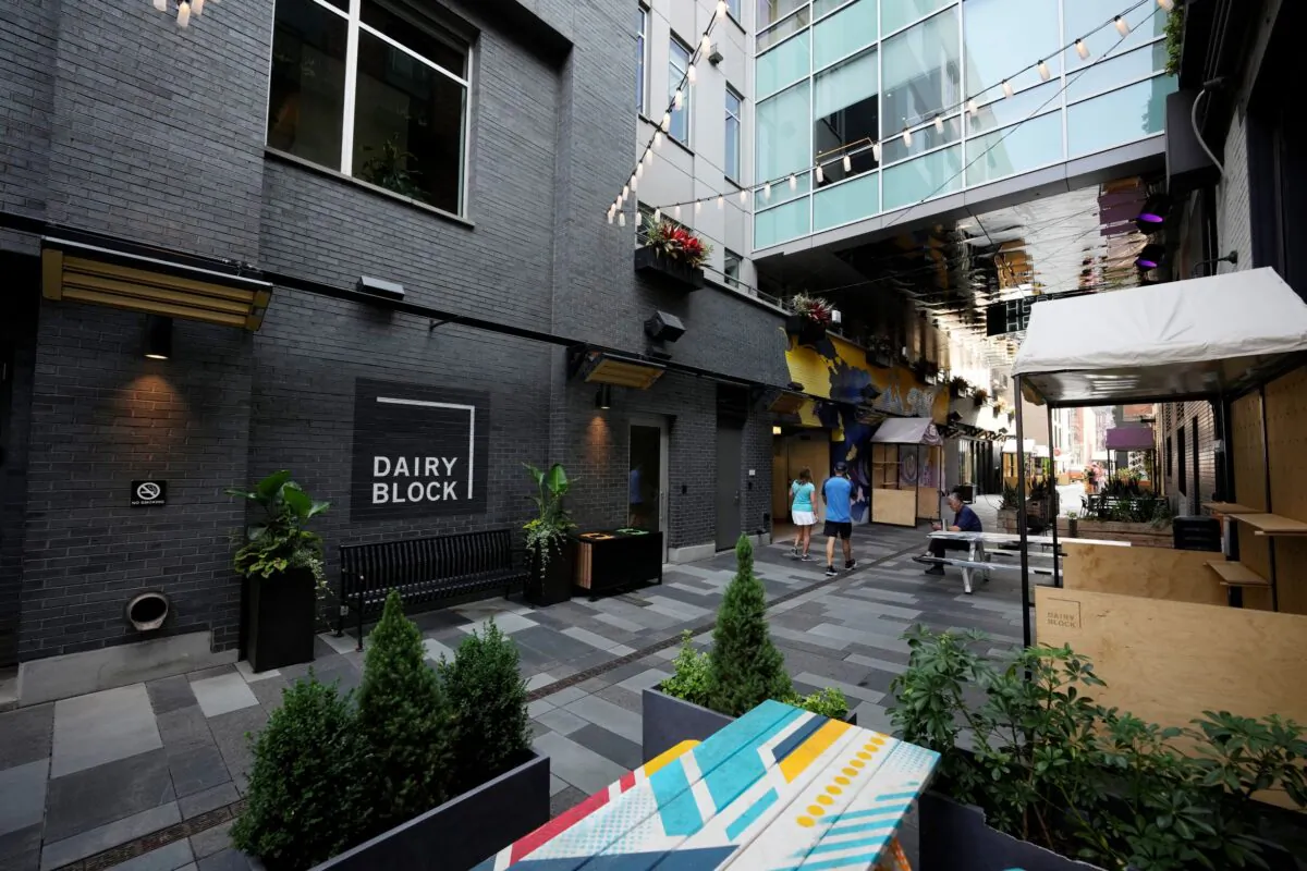 Pedestrians move through the alleyway in the Dairy Block and past the outside of the Maven Hotel in lower downtown Denver, Colo., on July 11, 2021. (David Zalubowski/AP Photo)