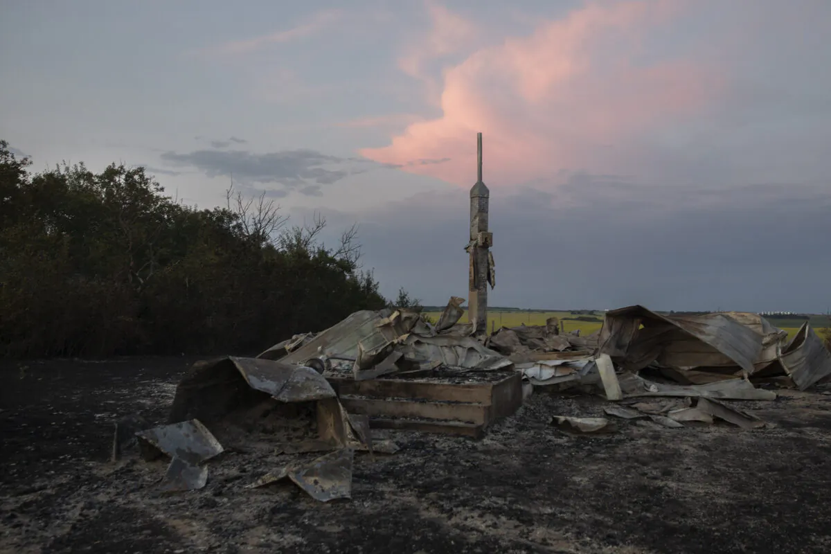 Ashes and debris are all that remain after a fire at the Holy Trinity Roman Catholic Church near Orolow, Sask., on July 8, 2021. (The Canadian Press/Kayle Neis)