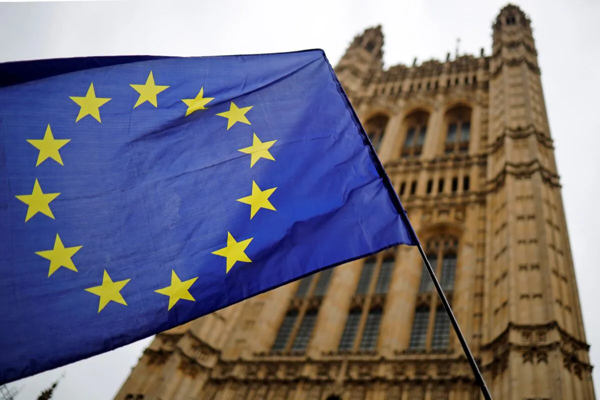 A European Union flag held by an activist outside the Houses of Parliament in London on Oct. 23, 2019. (Tolga Akmen/AFP via Getty Images)