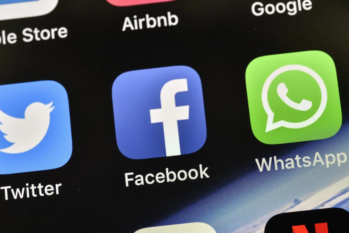 The icons of Facebook and WhatsApp are pictured on an iPhone, in Gelsenkirchen, Germany, on Nov. 15, 2018. (Martin Meissner/AP Photo)