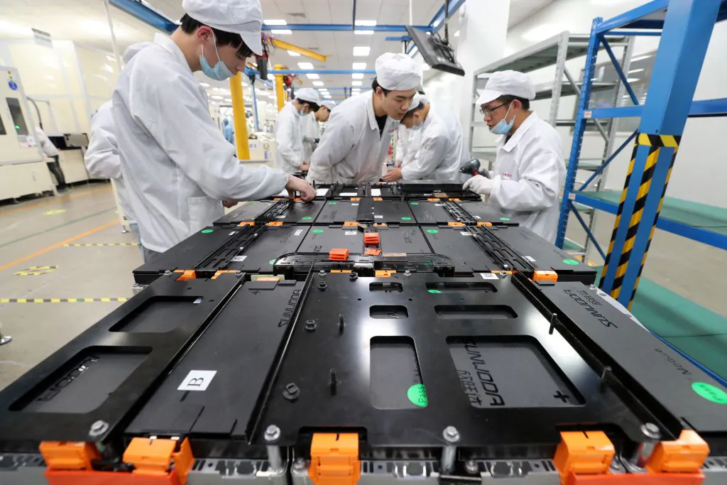 Workers at a factory for Xinwangda Electric Vehicle Battery, which makes lithium batteries for electric cars and other uses, in Nanjing, China, on March 12, 2021. (STR/AFP via Getty Images)