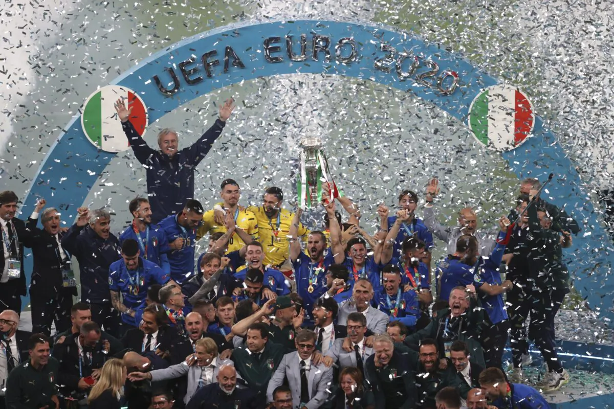 Italian team celebrates with the trophy after the Euro 2020 soccer final match between England and Italy at Wembley stadium in London, on July 11, 2021. (Catherine Ivill/Pool via AP)