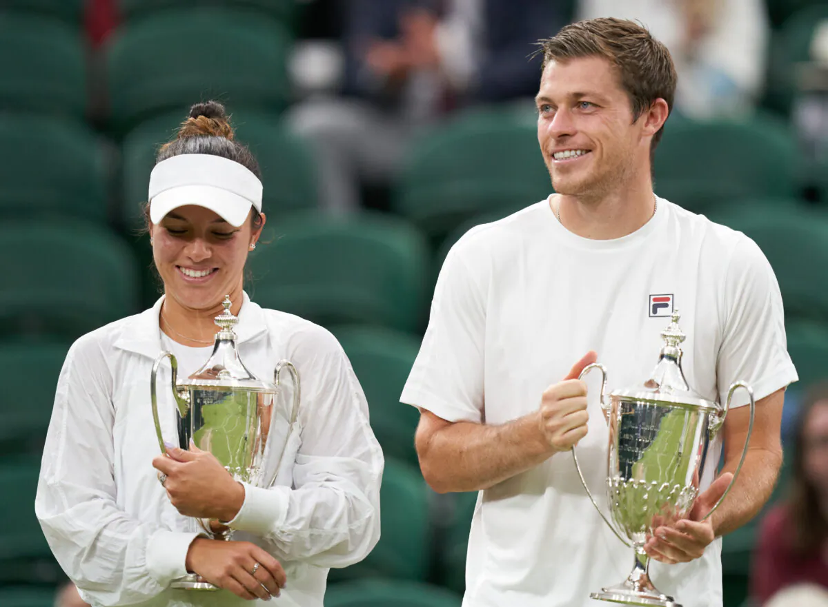 Desirae Krawczyk of USA and Neal Skupski of Great Britain celebrate winning the mixed doubles against Harriet Dart of Great Britain and Joe Salisbury of Great Britain while holding their trophies at the Wimbledon Tennis Championships in London, UK, on July 11, 2021. (Peter van den Berg/USA TODAY Sports via Reuters)