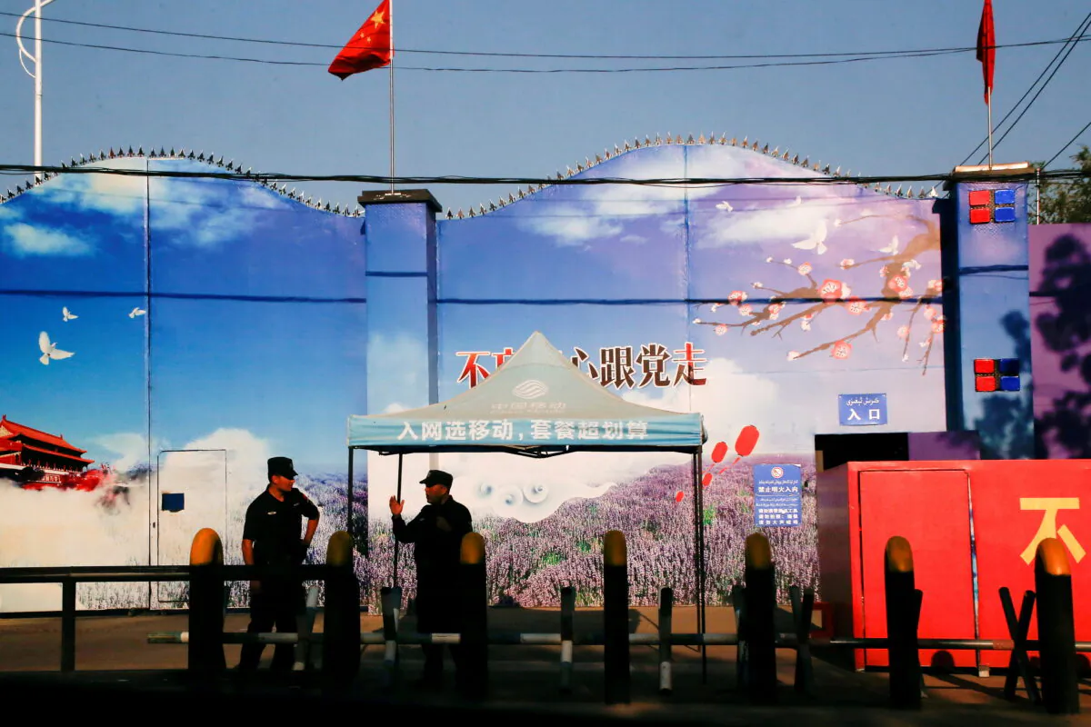 Security guards stand at the gates of what is officially known as a vocational skills education center in Xinjiang's Huocheng county in China on Sept. 3, 2018. (Reuters/Thomas Peter/File Photo)