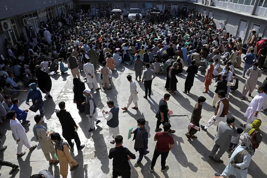 Afghans wait inside the passport office in Kabul, Afghanistan, on June 30, 2021. Afghans are lining up by the thousands at the Afghan Passport office to get new passports, possibly to leave, uncertain what tomorrow will bring as they witness the final withdrawal of the U.S. military and its NATO allies. (AP Photo/Rahmat Gul)