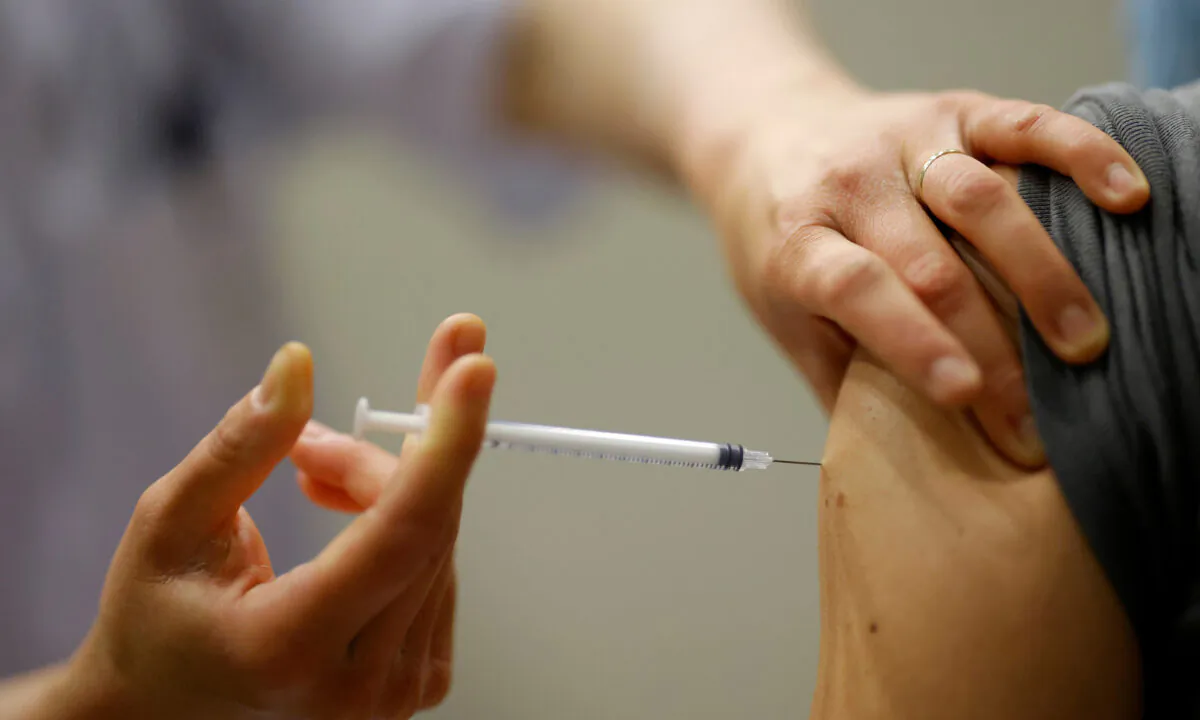 A healthcare worker administers a dose of the "Comirnaty" Pfizer BioNTech COVID-19 vaccine at the Parc des Expositions in Angers as part of the coronavirus disease (COVID-19) vaccination campaign in France on April 13, 2021. (Stephane Mahe/Reuters)
