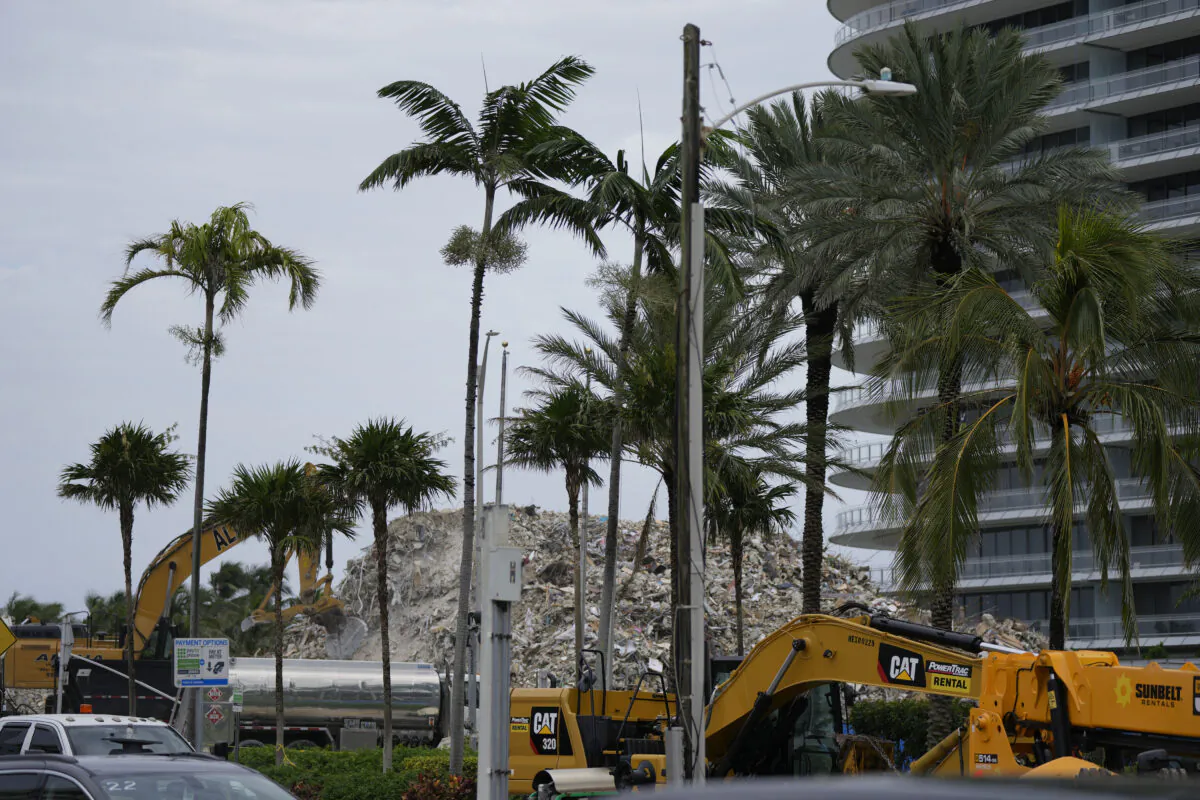 Crews work to clear the rubble of the demolished section of the Champlain Towers South building in Surfside, Fla., on July 12, 2021. (Rebecca Blackwell/AP Photo)