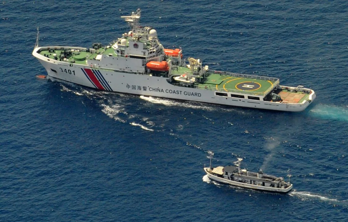 A China Coast Guard ship (top) and a Philippine supply boat engage in a standoff as the Philippine boat attempts to reach the Second Thomas Shoal, a remote South China Sea reef claimed by both countries, on March 29, 2014. (Jay Directo/AFP via Getty Images)