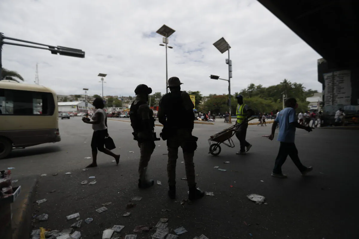 Police stand guard under an overpass in Port-au-Prince, Haiti, on July 12, 2021. (Fernando Llano/AP Photo)