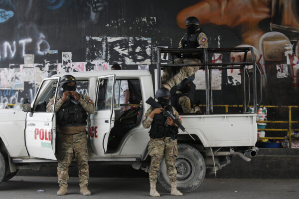 Police stand guard under an overpass in Port-au-Prince, Haiti, on July 12, 2021. (Fernando Llano/AP Photo)