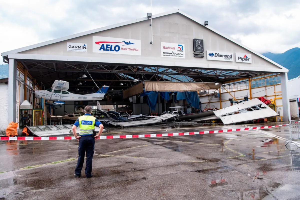 A hangar and some of the parked small planes at the local airport of Locarno in Magadino, southern Switzerland were heavily damaged after a thunderstorm on July 13, 2021. (Ti-Press/Elia Bianchi/Keystone via AP)

