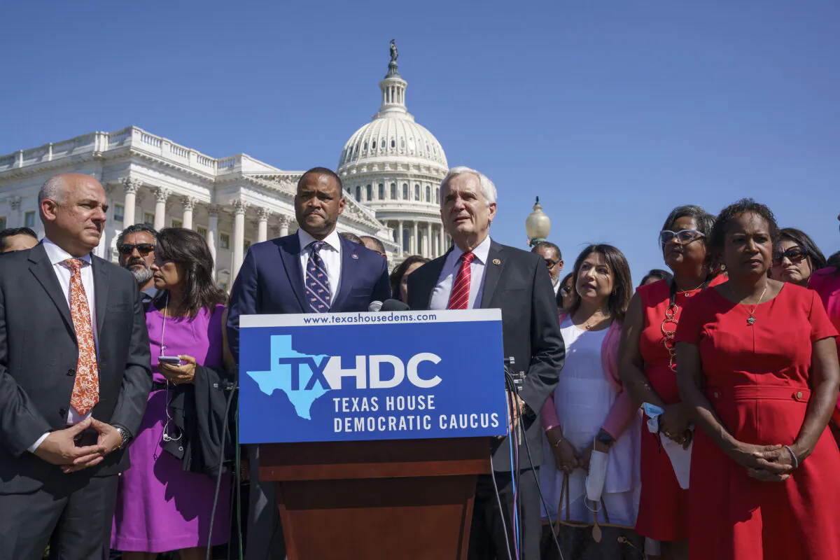 Rep. Marc Veasey, D-Texas, center left, and Rep. Lloyd Doggett, D-Texas, joined at left by Rep. Chris Turner, chairman of the Texas House Democratic Caucus, welcome Democratic members of the Texas legislature at a news conference at the Capitol in Washington, Tuesday, July 13, 2021. The lawmakers left Austin hoping to deprive the Texas Legislature of a quorum — the minimum number of representatives who have to be present for the body to operate, as they try to kill a Republican bill making it harder to vote in the Lone Star State. (AP Photo/J. Scott Applewhite)