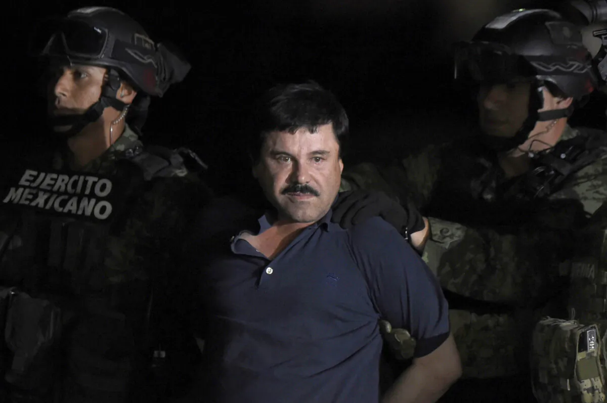 Drug kingpin Joaquin "El Chapo" Guzman is escorted into a helicopter at Mexico City's airport following his recapture by the Mexican military in Los Mochis, in Sinaloa State on Jan. 8, 2016. (Alfredo Estrella/AFP/Getty Images)