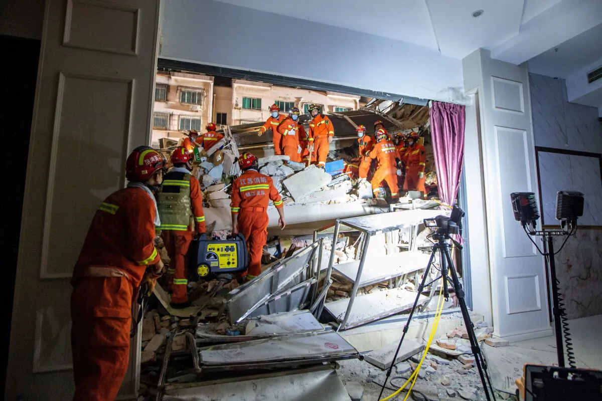 Rescue workers work at the site where a hotel building collapsed in Suzhou, Jiangsu province, China, on July 12, 2021. (China Daily via Reuters)