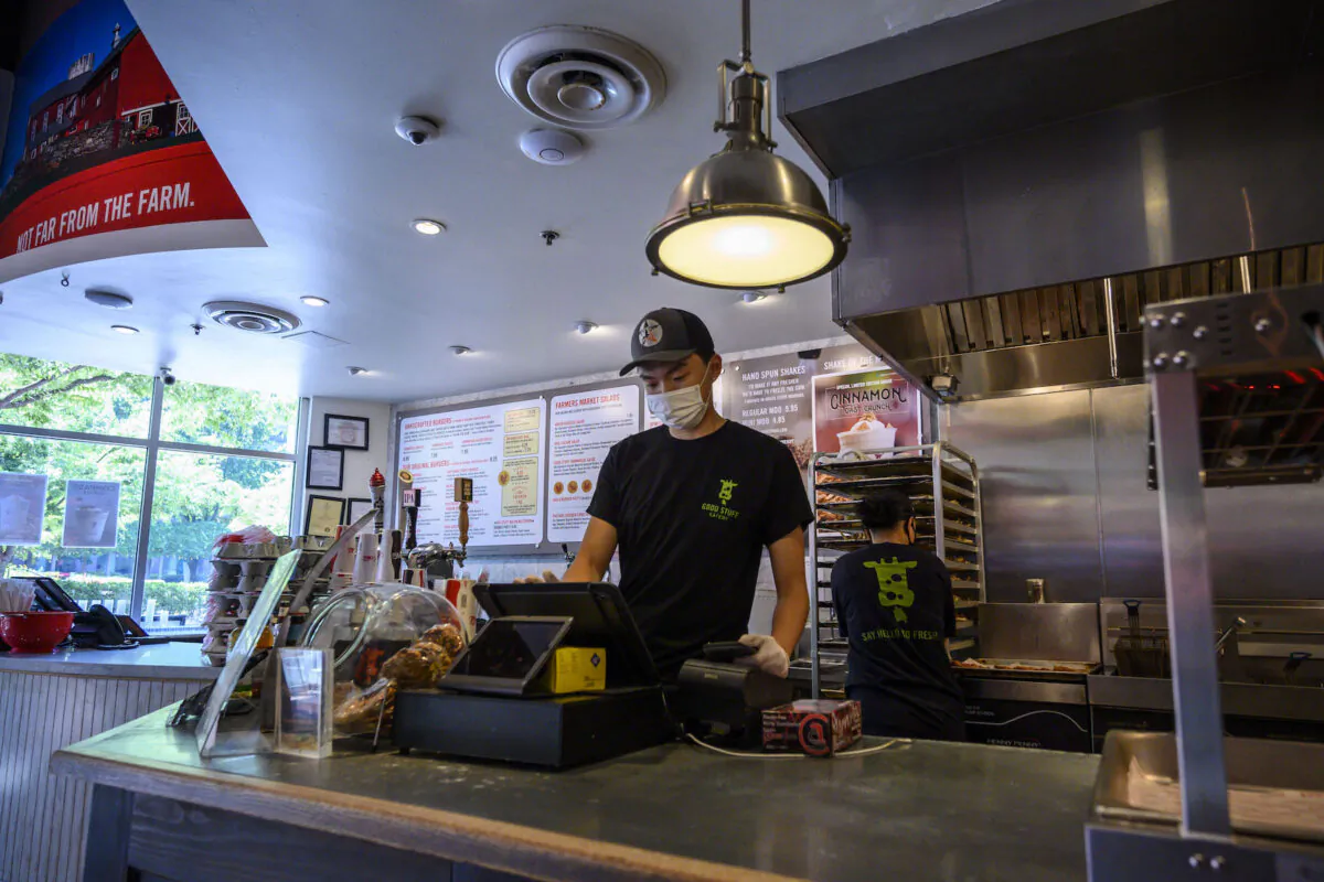 A teenager at work in a fast food restaurant in Arlington, Va., on June 6, 2021.  (ERIC BARADAT/AFP via Getty Images)