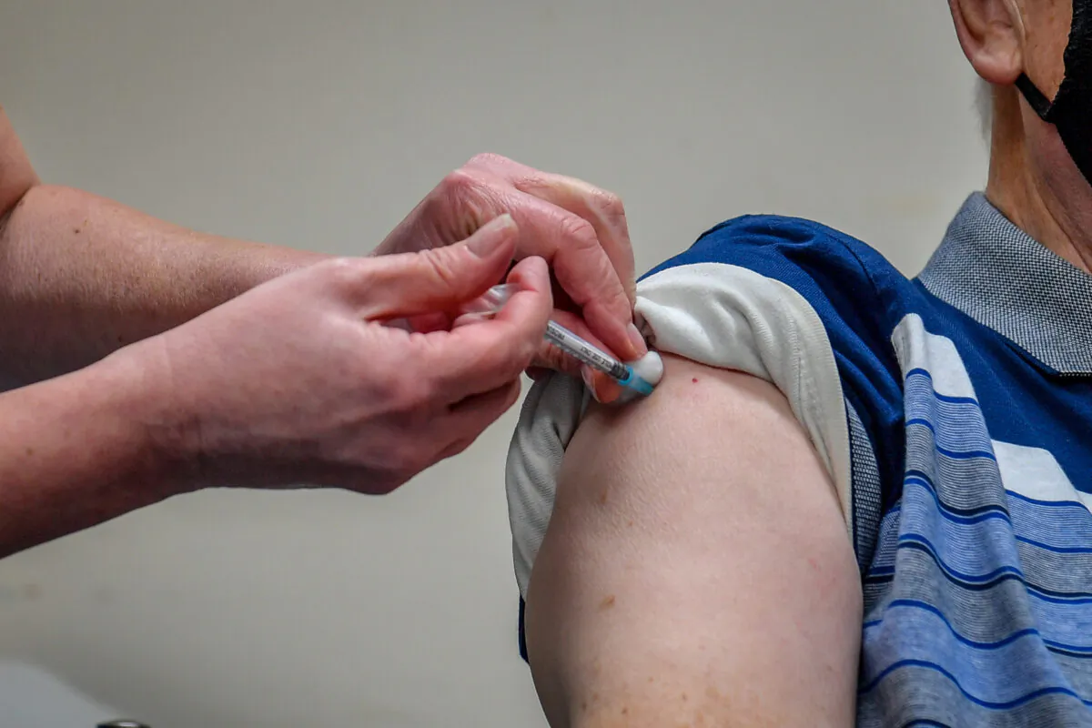 A man receiving a COVID-19 vaccine at an unknown location on July 10, 2021. (Ben Birchall/PA)