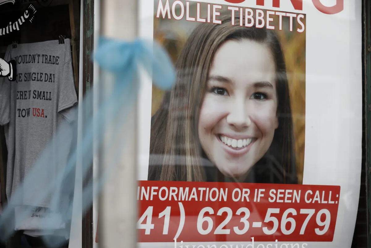 A poster for missing University of Iowa student Mollie Tibbetts hangs in the window of a local business in Brooklyn, Iowa on Aug. 21, 2018. (Charlie Neibergall/AP Photo, File)