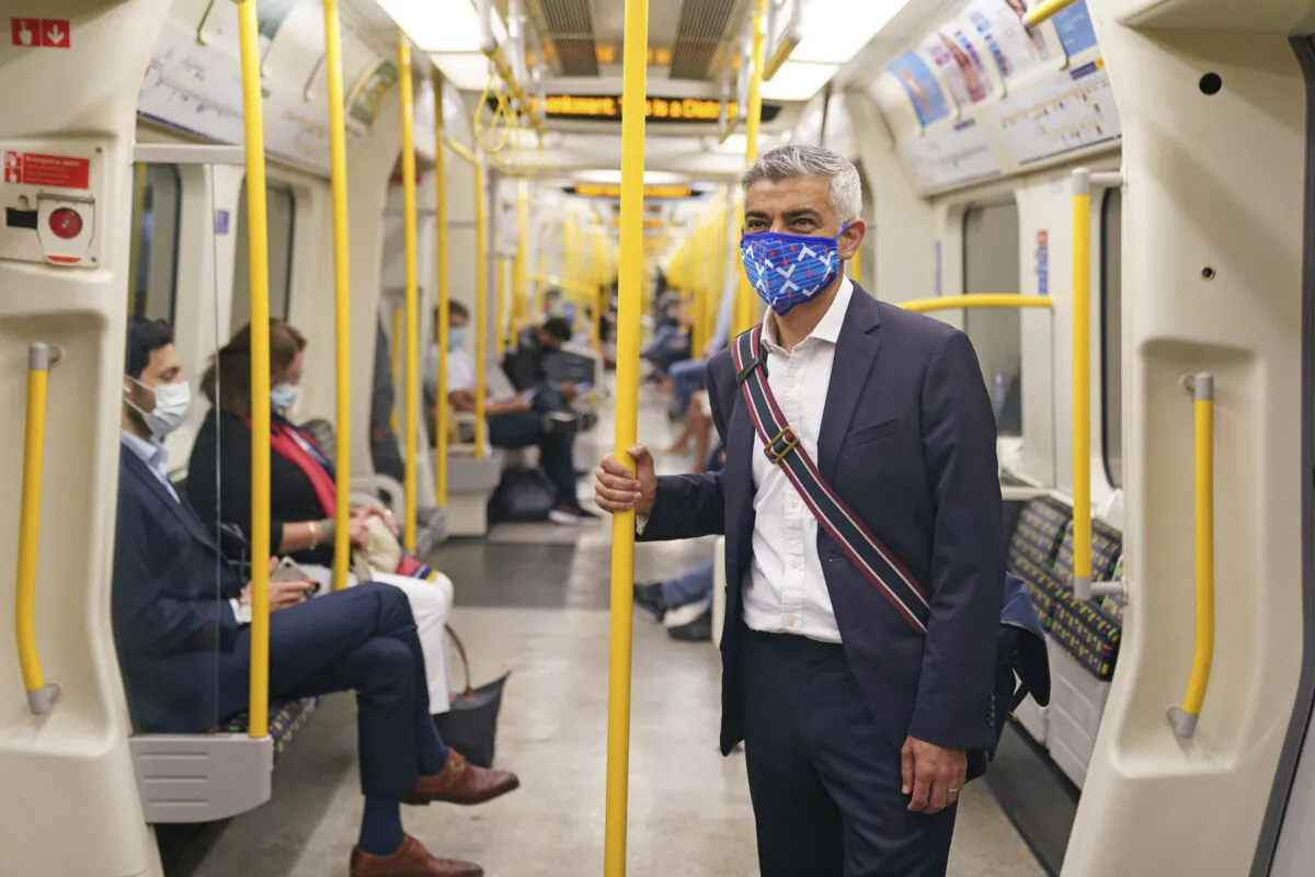 Mayor of London Sadiq Khan wears a mask as he rides on a Circle Line tube train to visit the London Transport Museum, in London, on July 14, 2021. (Kirsty O'Connor/PA via AP)