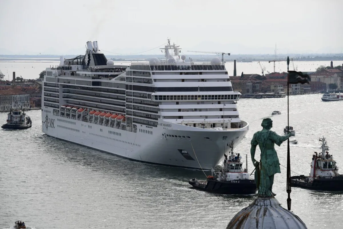 A MSC Magnifica cruise ship, seen from San Maggiore's bell tower, carried by three tugboats arriving in the Venice Lagoon on June 9, 2019. (Miguel Medina/AFP via Getty Images)