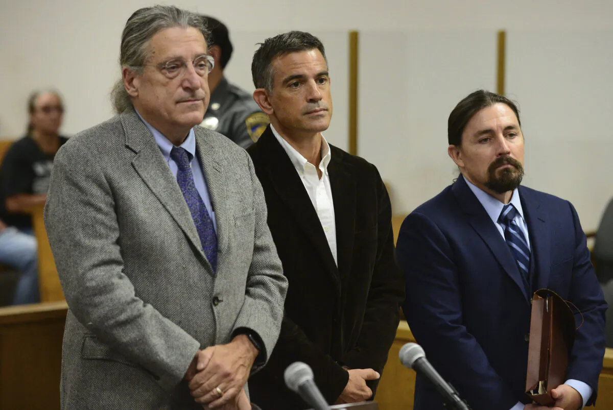 In this Sept. 12, 2019, file photo, Fotis Dulos, center, appears with his attorney Norm Pattis, left, during Dulos' arraignment on a new tampering with evidence charge at state Superior Court in Norwalk, Conn. (Erik Trautmann/Hearst Connecticut Media via AP, Pool)