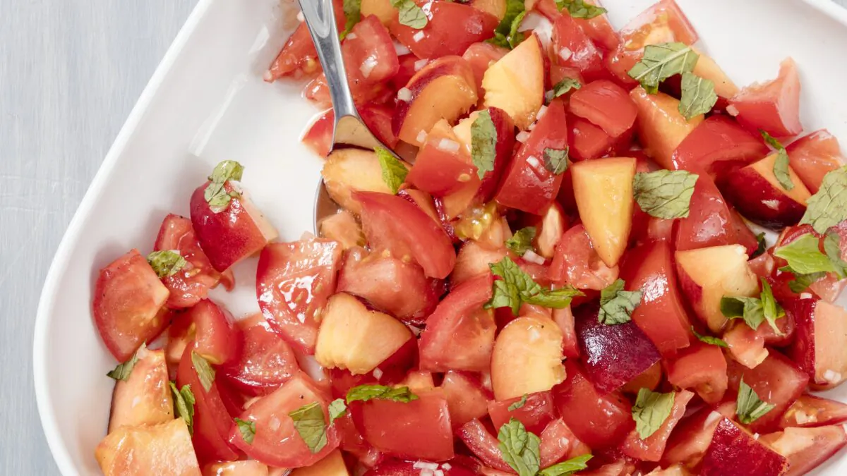 Tomatoes and peaches are at their ripest (and juiciest!) in summer, making this salad a perfect picnic side dish. (Elle Simone)