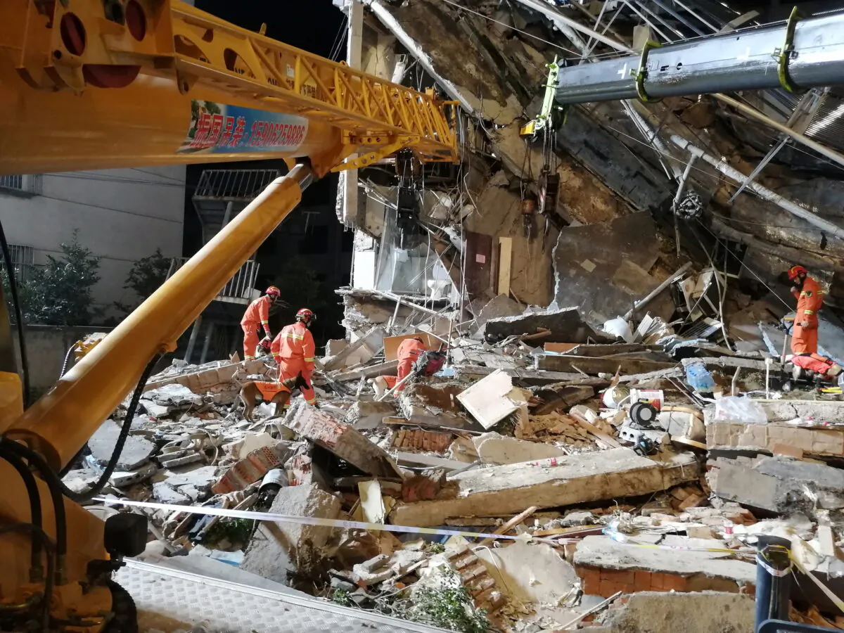 Rescue workers work at the site where a hotel building collapsed in Suzhou, Jiangsu province, China July 13, 2021. (China Daily via Reuters)