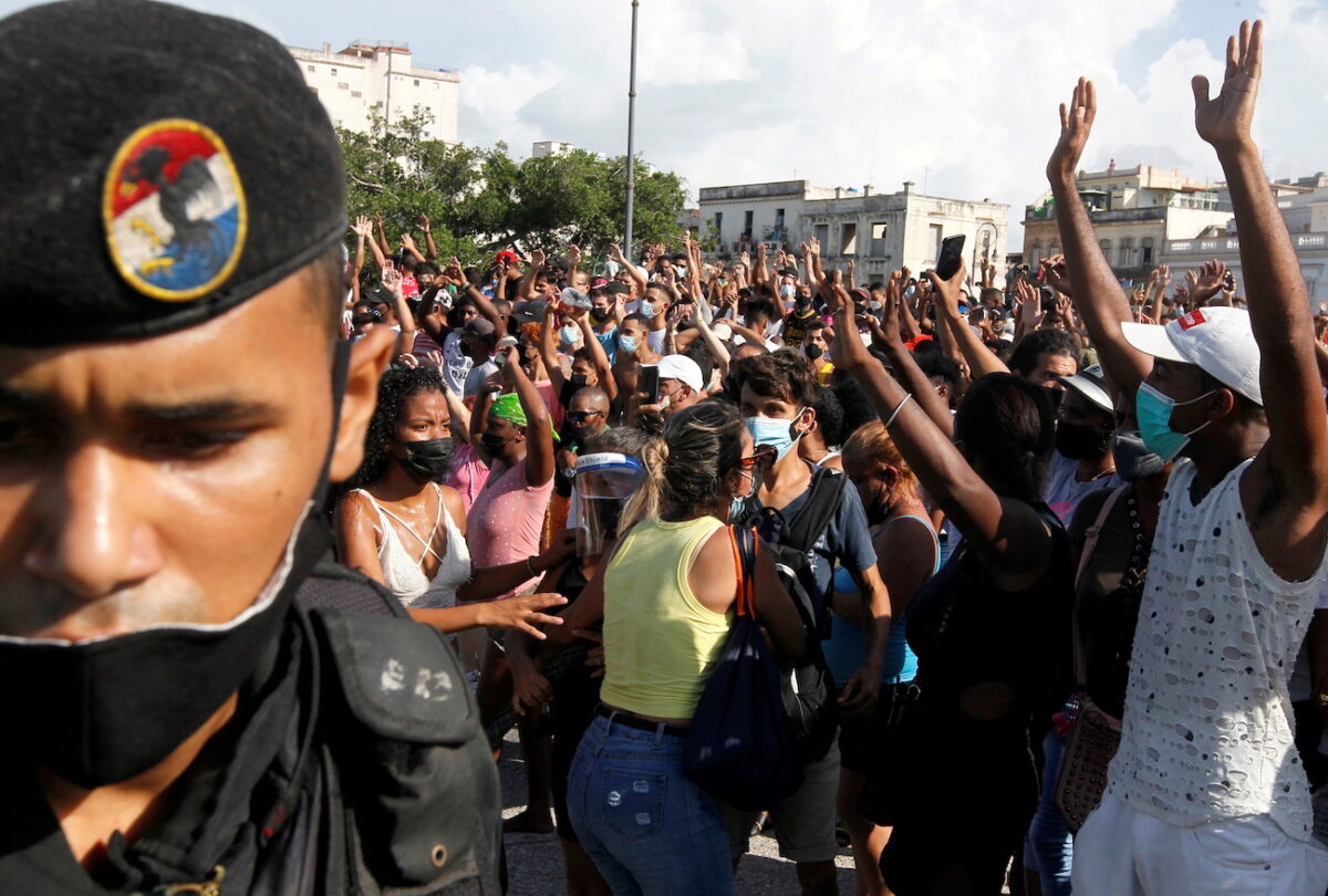 People react during protests against and in support of the government, in Havana