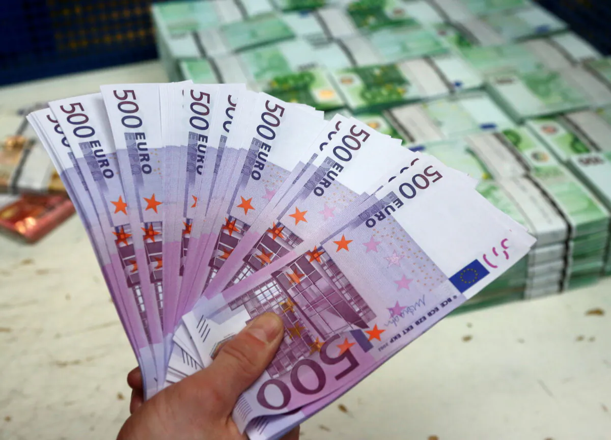 An employee holds 500 euro banknotes in the Money Service Austria company's headquarters in Vienna, Austria, on March 3, 2016. (Leonhard Foeger/Reuters)