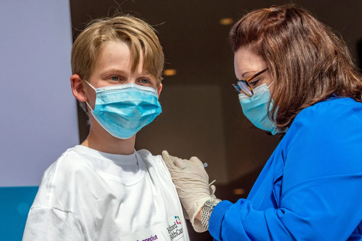 A 13-year-old boys receives vaccine at the Connecticut Convention Center in Hartford, Connecticut on May 13, 2021.(Joseph Prezioso/AFP via Getty Images)