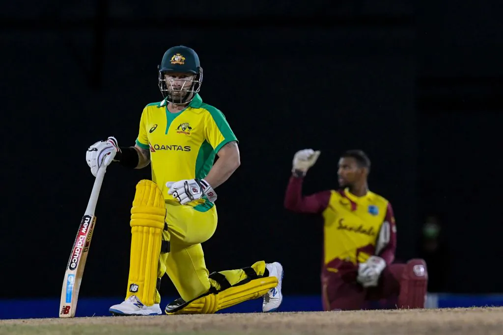 Matthew Wade (L) of Australia kneels for Black Lives Matter during the 4th T20I between Australia and West Indies at Darren Sammy Cricket Ground, Gros Islet, Saint Lucia, on July 14, 2021. (Randy Brooks/AFP via Getty Images)