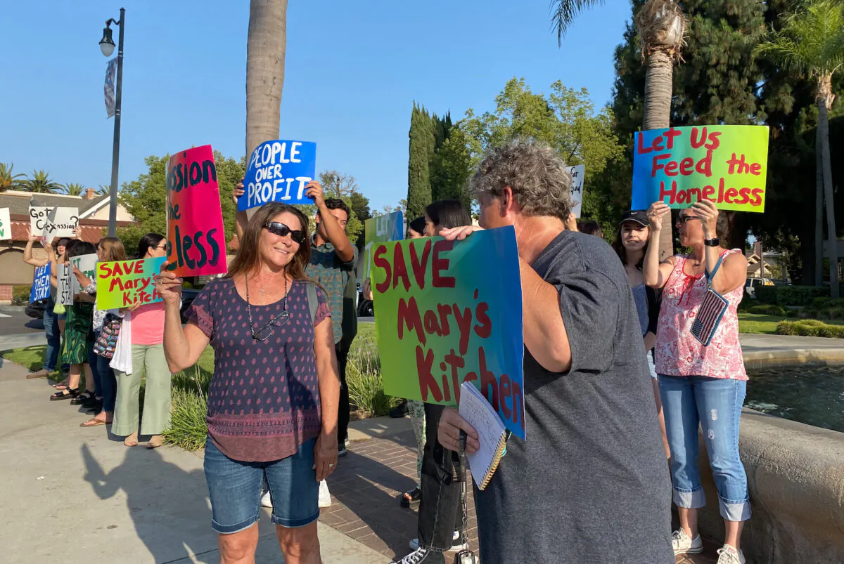 Community members protest the city of Orange's decision to shut down Mary's Kitchen, a soup kitchen for the homeless, in Orange, Calif., on July 13, 2021. (Chris Karr/The Epoch Times)