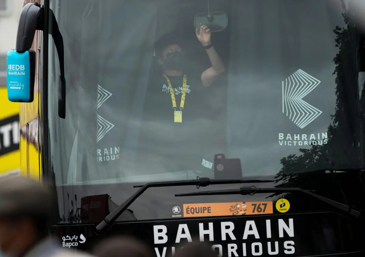 A member of the Bahrain Victorious team closes the curtains in team the bus prior to the eighteenth stage of the Tour de France cycling race over 129.7 kilometers (80.6 miles) with start in Pau and finish in Luz Ardiden, France, on July 15, 2021. (Christophe Ena/AP Photo)