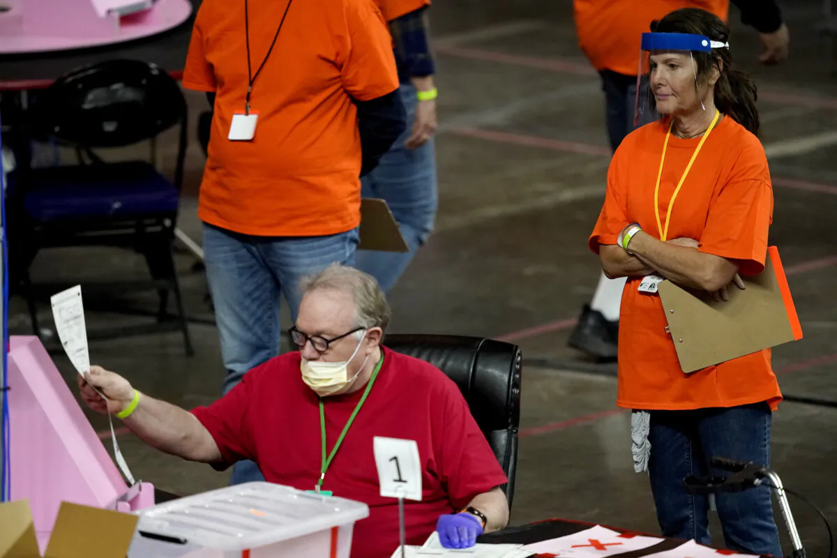 Maricopa County ballots cast in the 2020 general election are examined and recounted by contractors working for Florida-based company, Cyber Ninjas at Veterans Memorial Coliseum in Phoenix, Ariz., on May 6, 2021. (Matt York, Pool/AP Photo)