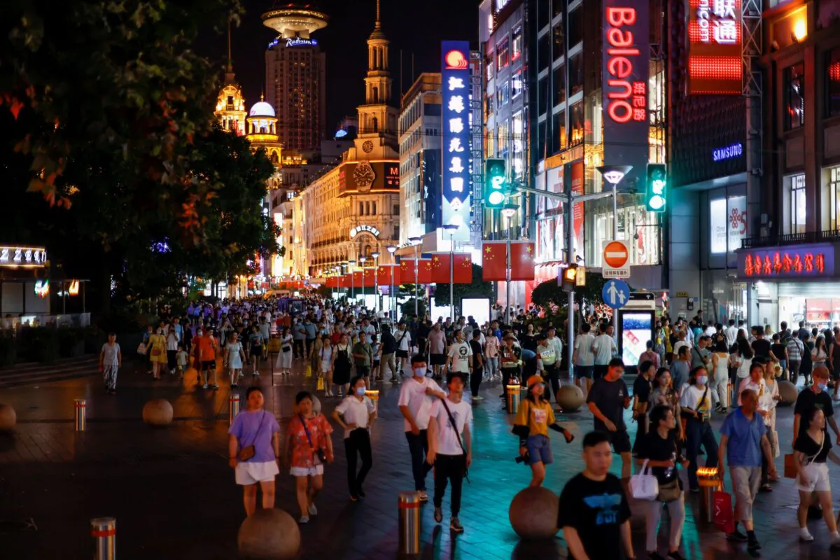 People visit a main shopping area in Shanghai, China, on July 12, 2021. (Aly Song/Reuters)