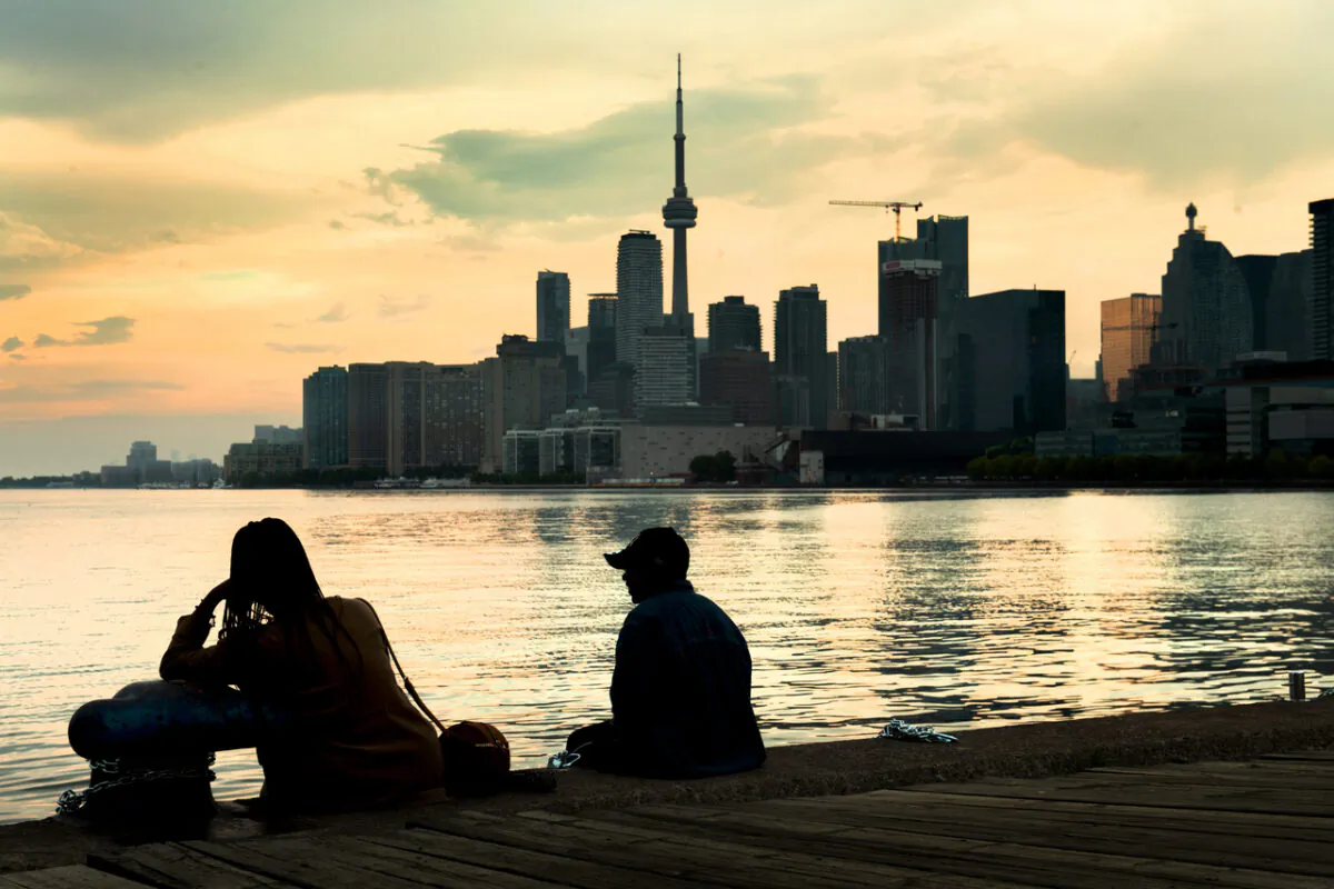 People watch the Toronto skyline on June 8, 2021. (The Canadian Press/Frank Gunn)