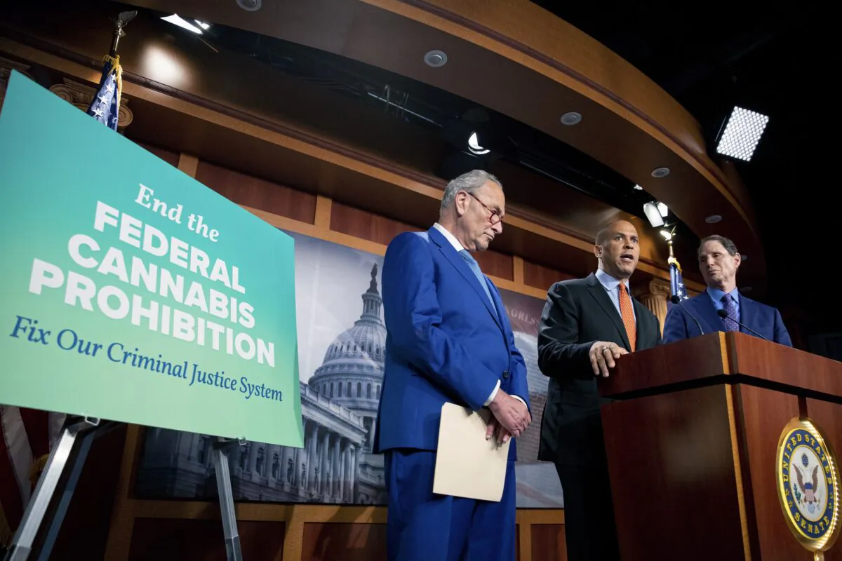 (L-R) Senate Majority Leader Chuck Schumer (D-N.Y.), Sen. Cory Booker (D-N.J.), and Sen. Ron Wyden (D-Ore.) announce a draft bill that would decriminalize marijuana on a federal level, in Capitol Hill in Washington on July 14, 2021. (Amanda Andrade-Rhoades/AP Photo)