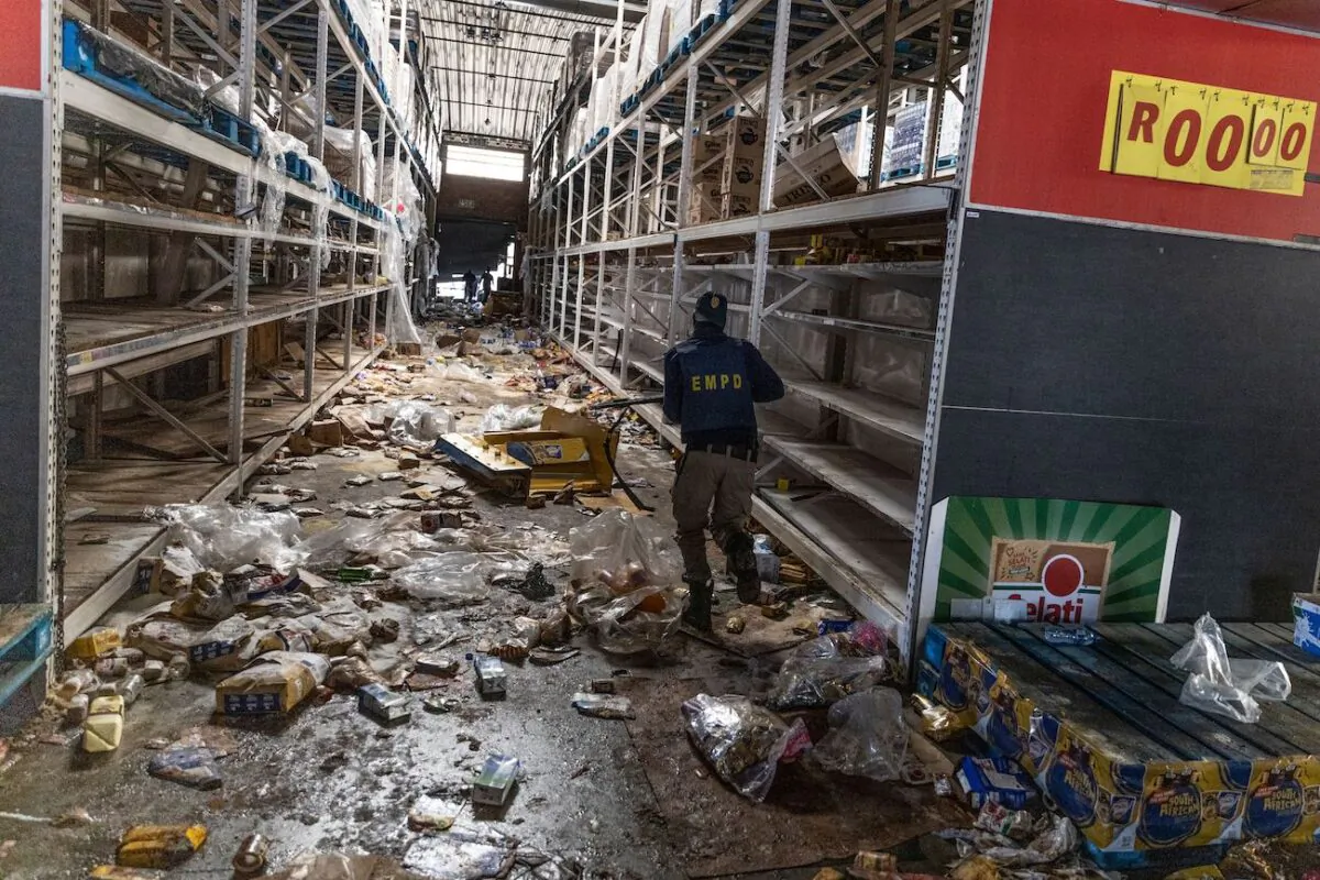 A member of the South African Police Services searches for looters inside the Gold Spot Shopping Centre in Vosloorus, southeast of Johannesburg, on July 12, 2021. (Guillem Sartorio/AFP via Getty Images)